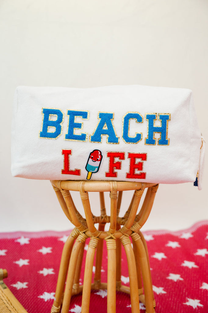 White large terry bag with "Beach" in blue letter and "Life" in red letters with a popsicle patch as the "I"