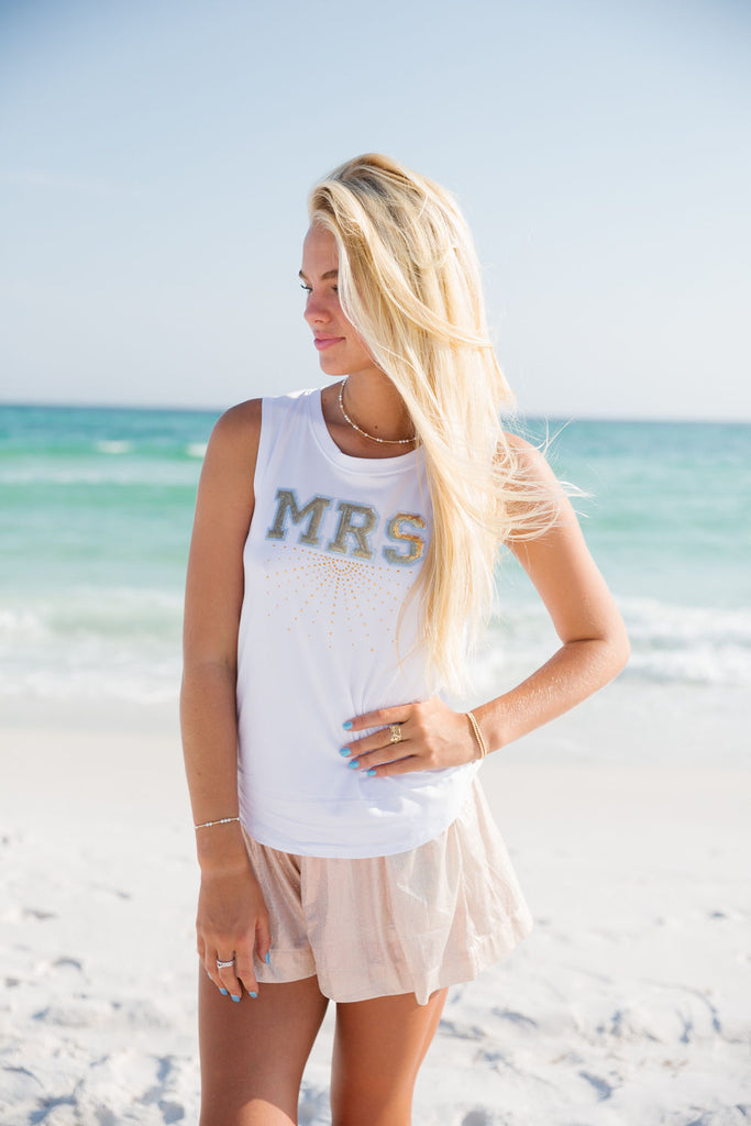 White tank top with gold "Mrs" text across the front with gold rhinestones. 