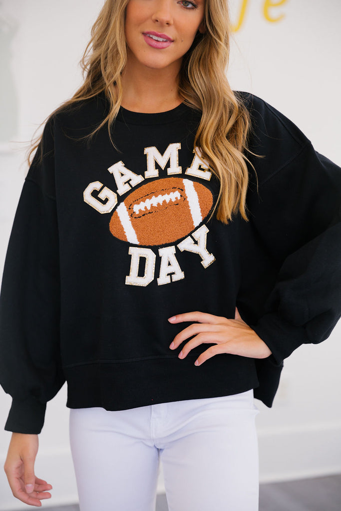 Black pullover with "game day" in mini white glam lettering with football patch. 