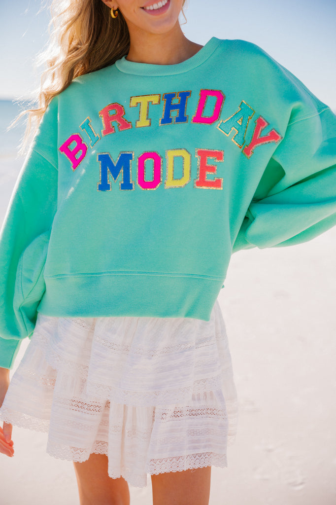 Mint cropped pullover with Birthday Mode in rainbow terry letters
