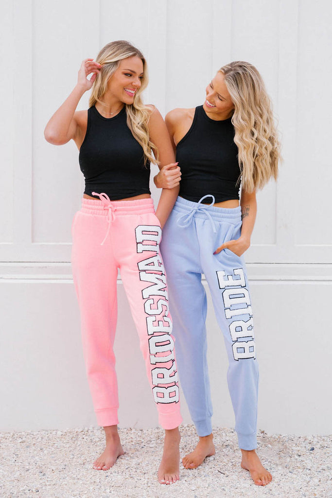 Pink or blue sweatpants with "Bride" or "Bridesmaid" down the sides in white letters