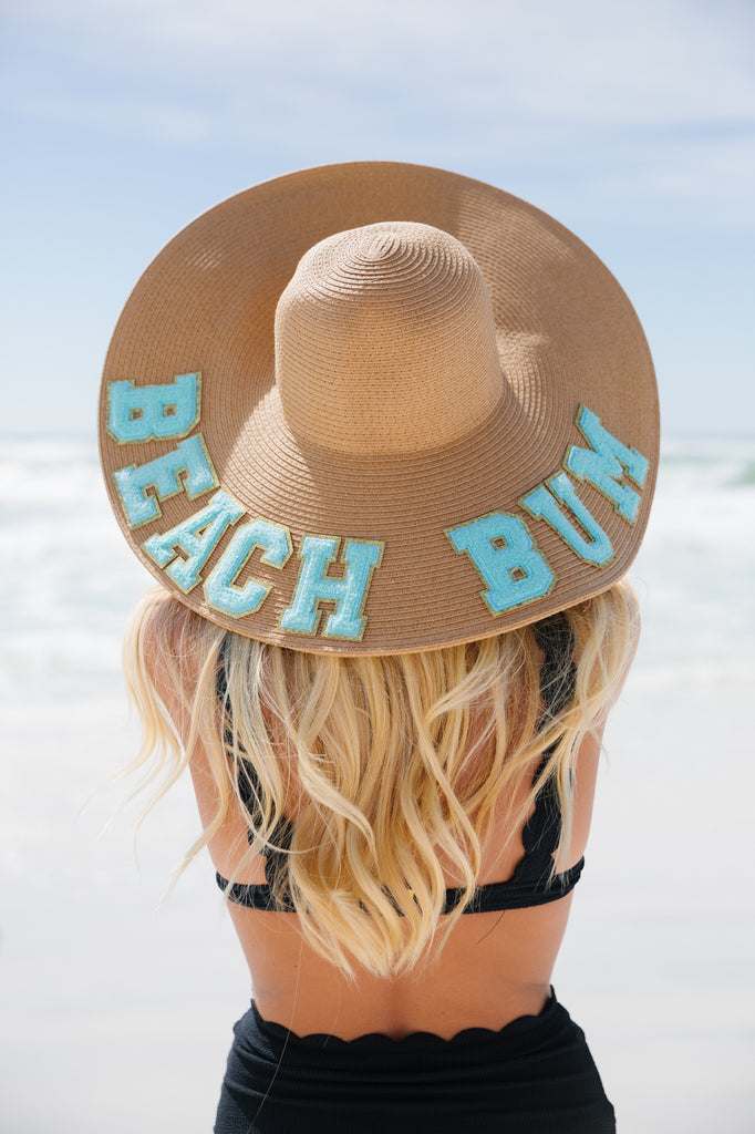 Floppy sun hat with Beach Bum in teal glam letters