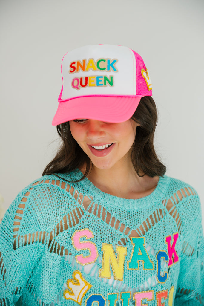 Hot pink and white trucker with Snack Queen patch and crown patch on the side