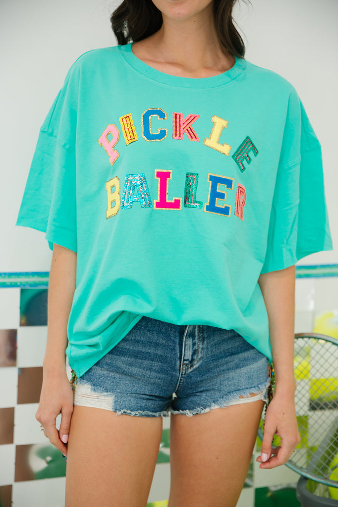 Teal tee with "pickle baller" in sequin and terry lettering. 