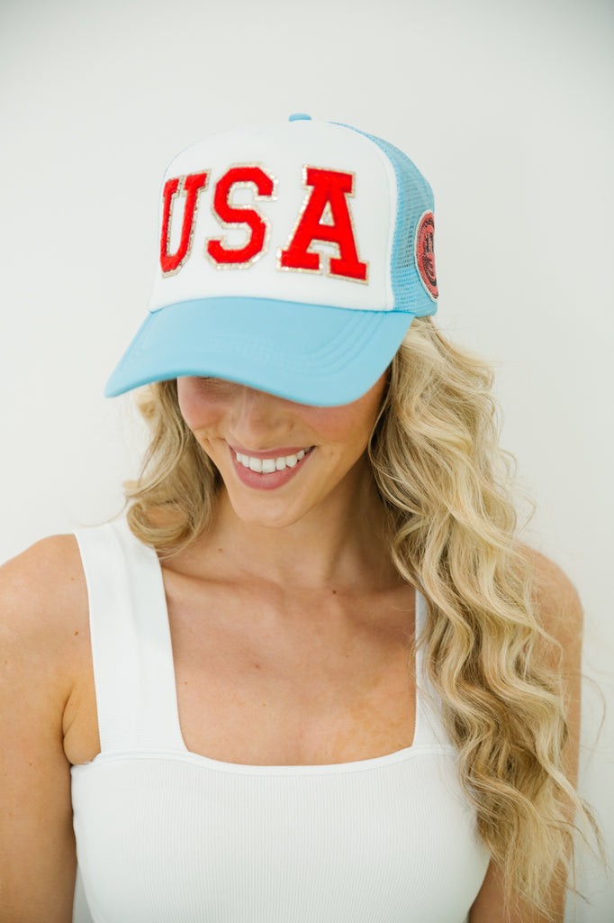 Blue and white trucker hat  with red "USA" letters