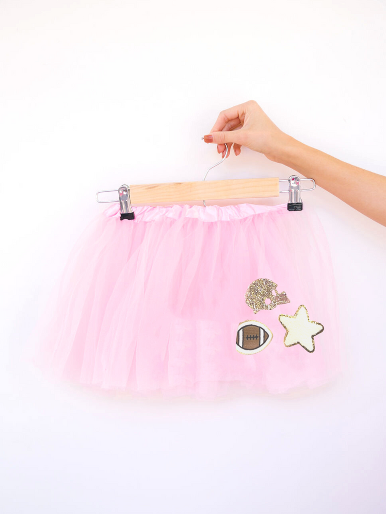 Pink tutu with football patch, white terry star patch, and a rhinestone helmet patch. 