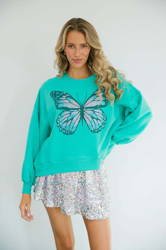 Teal cropped pullover with metallic butterfly patch