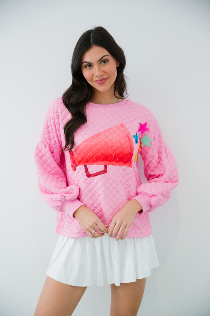 Pink quilted pullover with a megaphone print and star patches