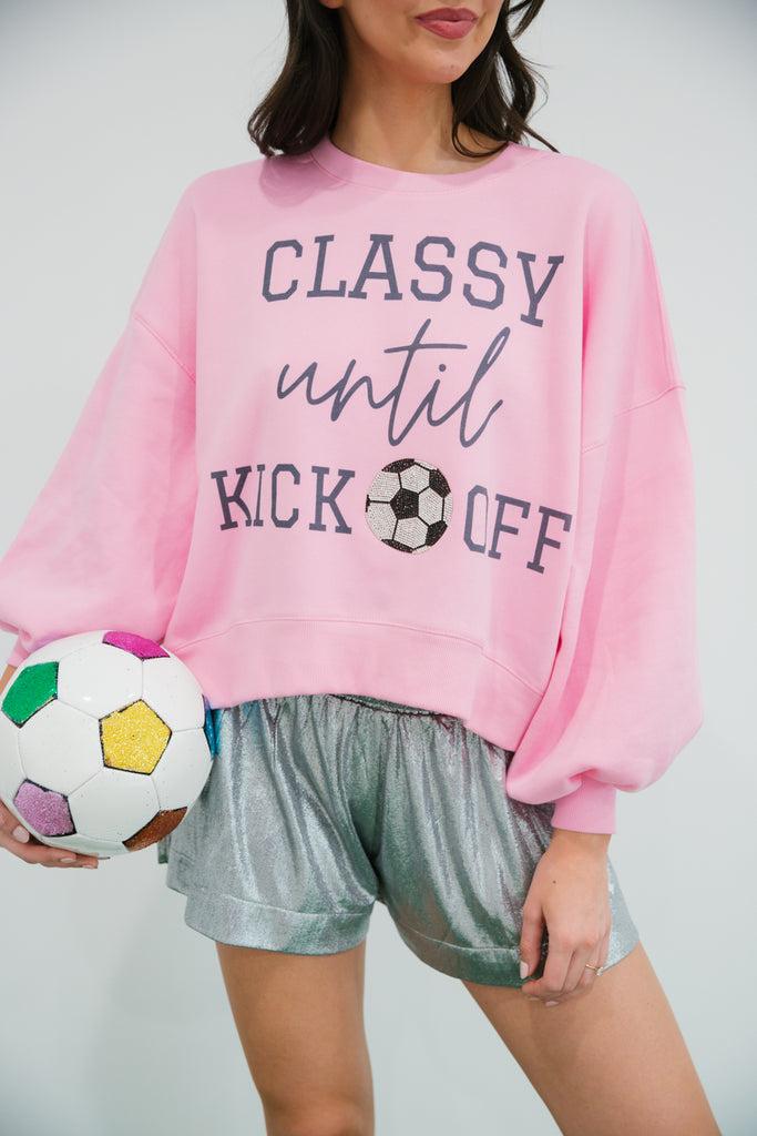 Pink cropped pullover with Classy Until Kick Off print and soccer ball patch