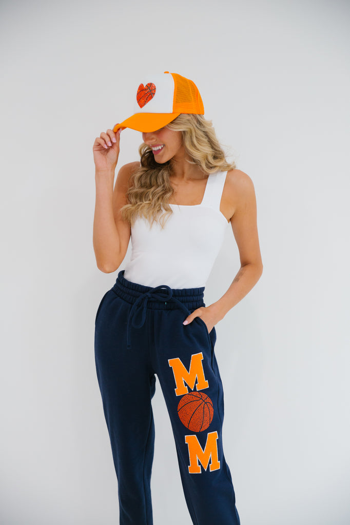 Navy sweatpants with Mom in orange varsity letters and basketball patch