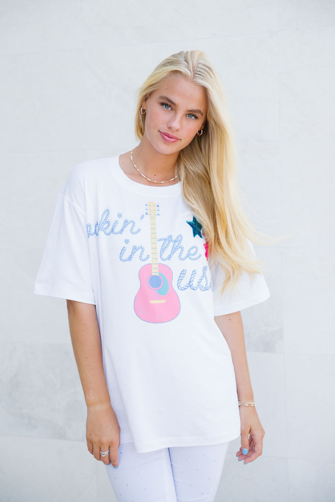 White tee with Rockin' In The USA guitar print and sequin star patches.