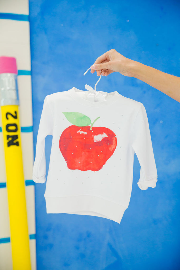 White pullover with red apple print