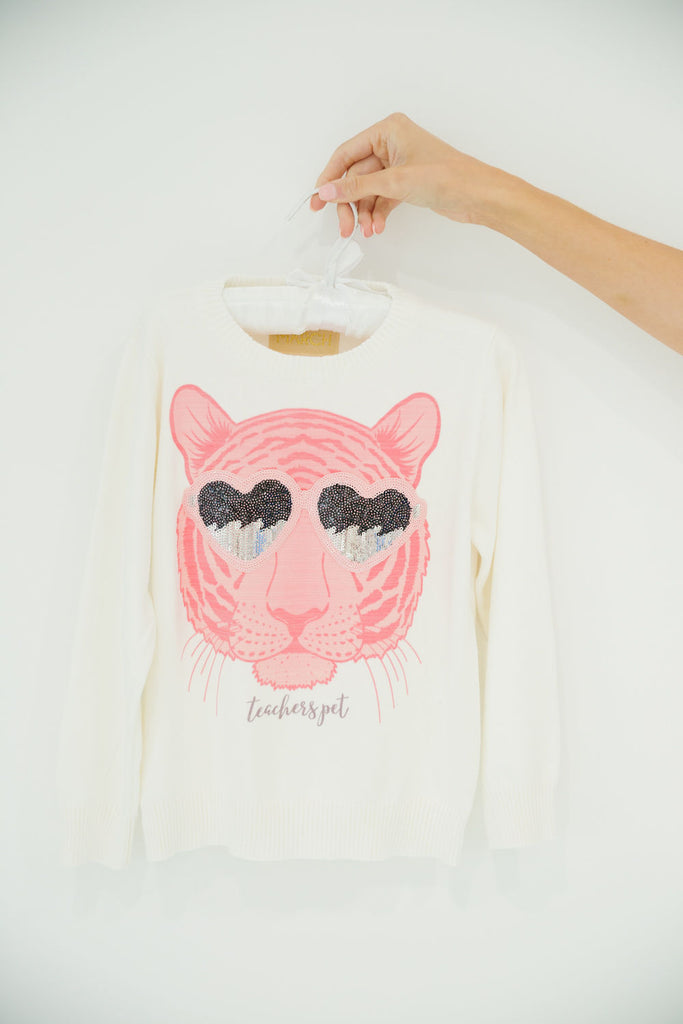 White sweater with pink tiger head print and sunglasses