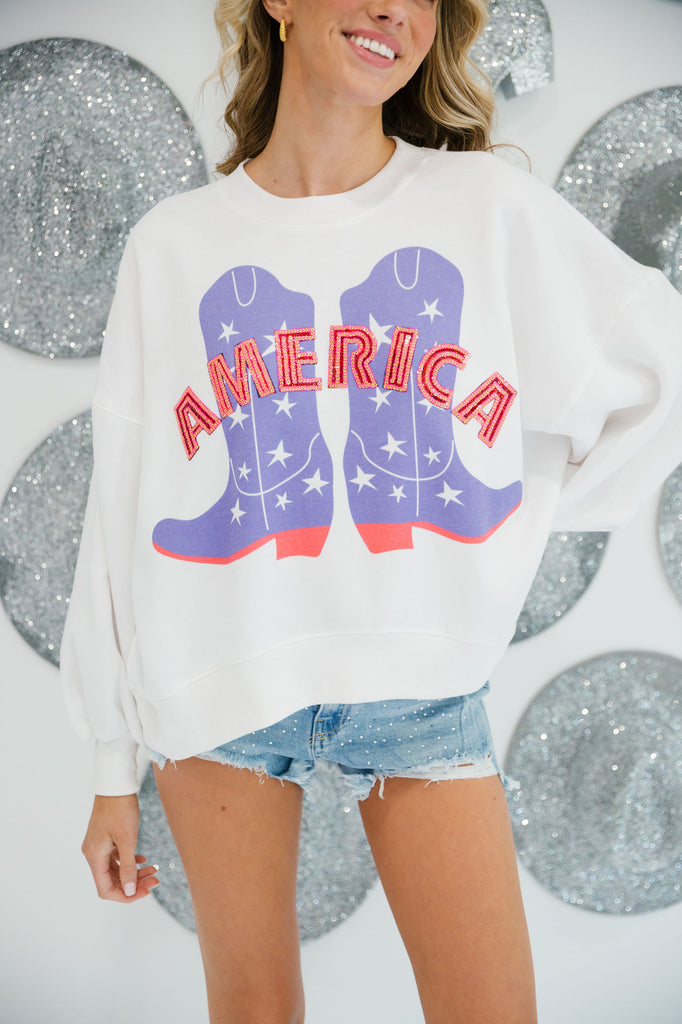 White cropped pullover with cowboy boots print and "America" in pink sequin letters