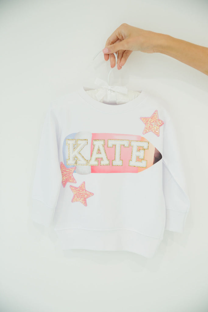 White pullover with pencil print and customizable letters and patches