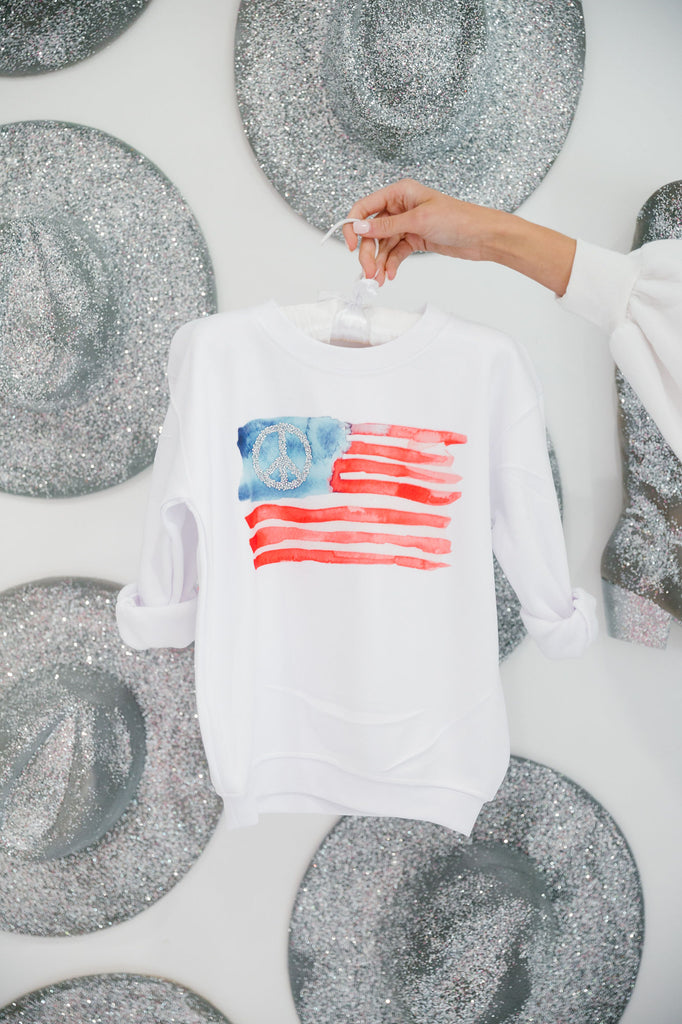Kids white pullover with a watercolor American flag and silver peace sign