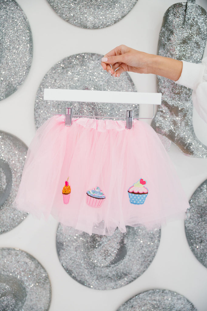 Pink tutu with cupcake patches. 