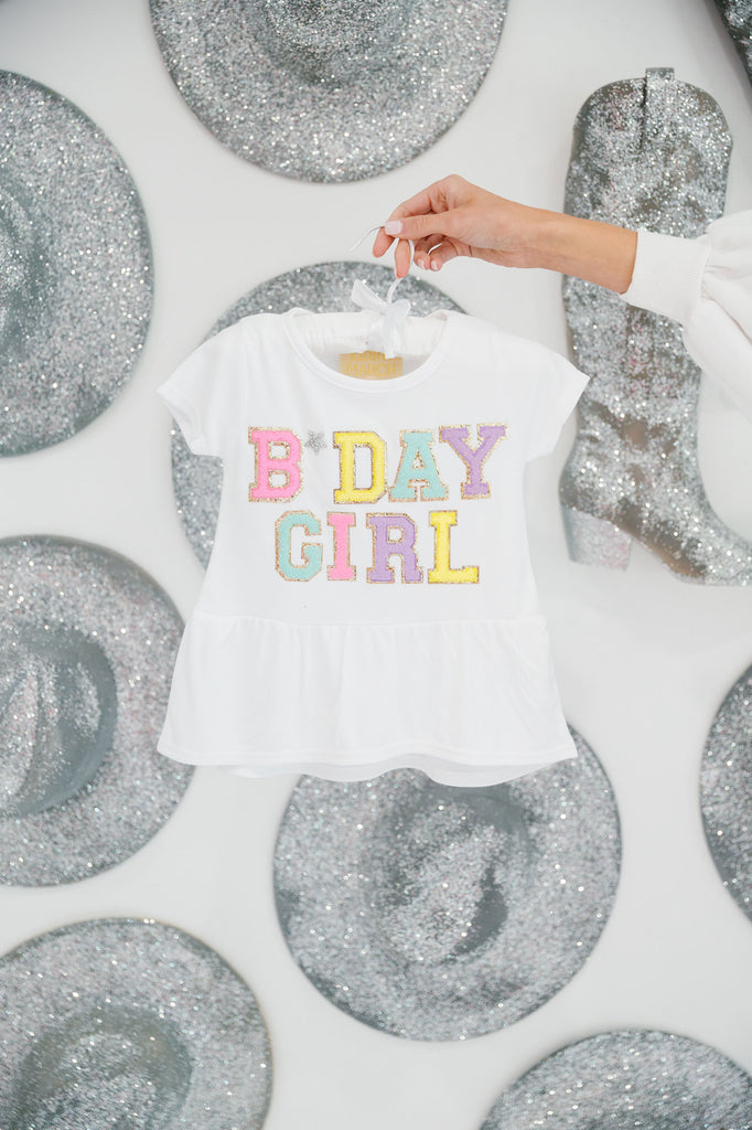 Kids white top with ruffle and "bday girl" in colorful mini terry lettering and a silver rhinestone heart.