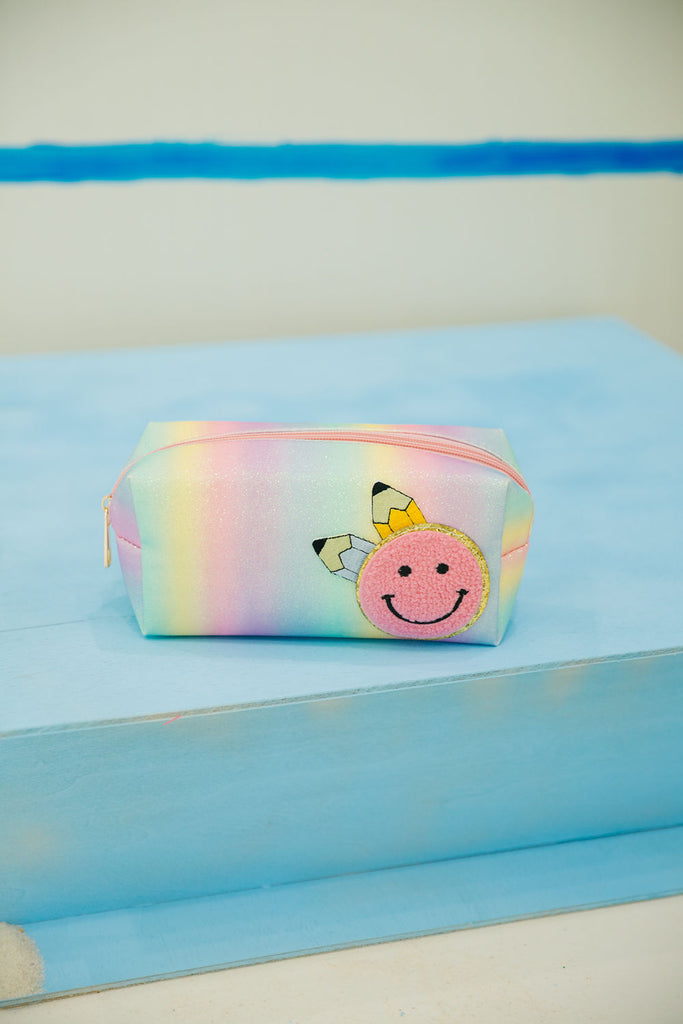 Pastel rainbow glitter bag with pencil and smiley face patch