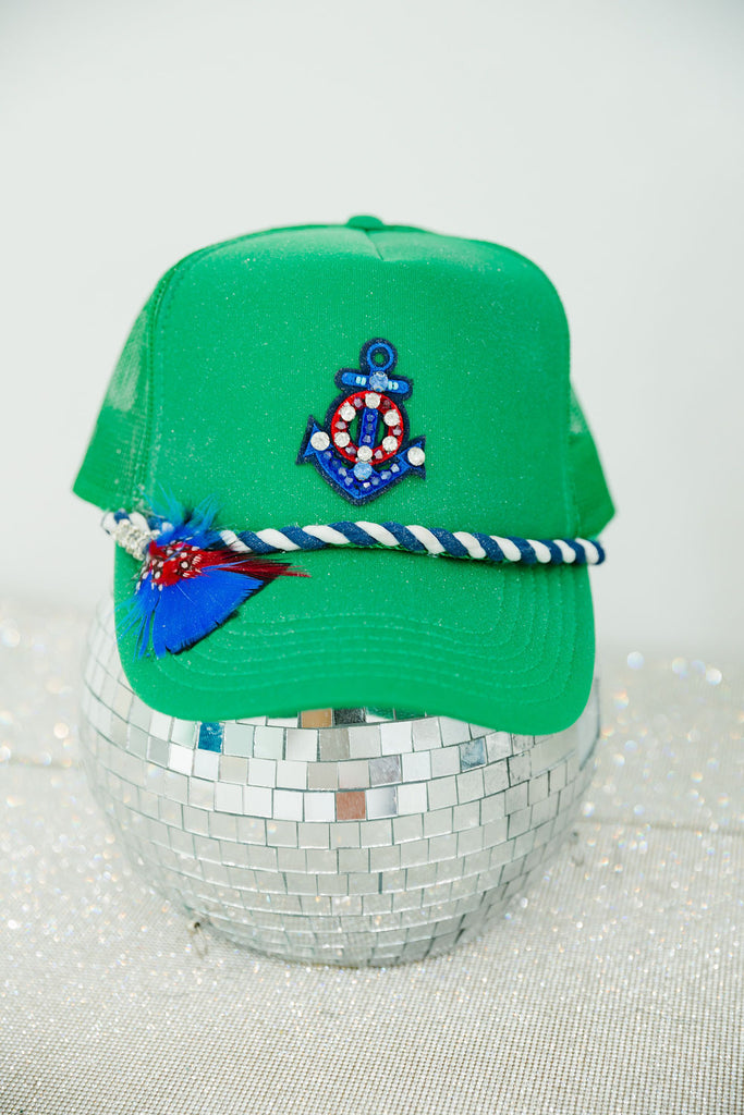 Green trucker hat with anchor patch, blue rope band, feathers, and a glitter option
