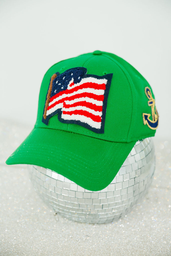 Green structured hat with American flag patch and anchor patch on the side