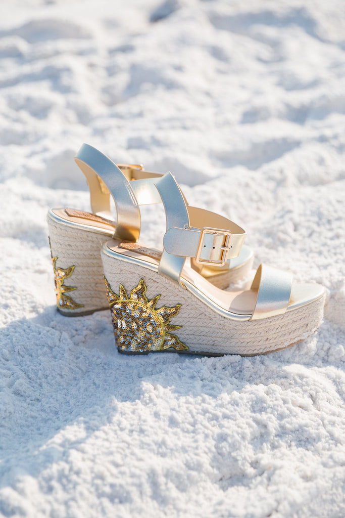 Gold wedges with sequin sun heels. 