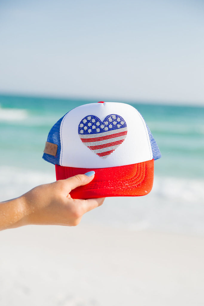 Kids red, white, and blue trucker hat with American flag heart. 