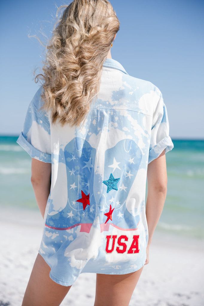 Blue tie dye short-sleeve button down with cowboy boots print across the back with red "USA" letters and stars