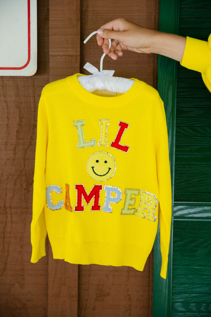 Kids yellow sweater with "lil camper" in colorful mini terry lettering and a yellow smiley patch. 