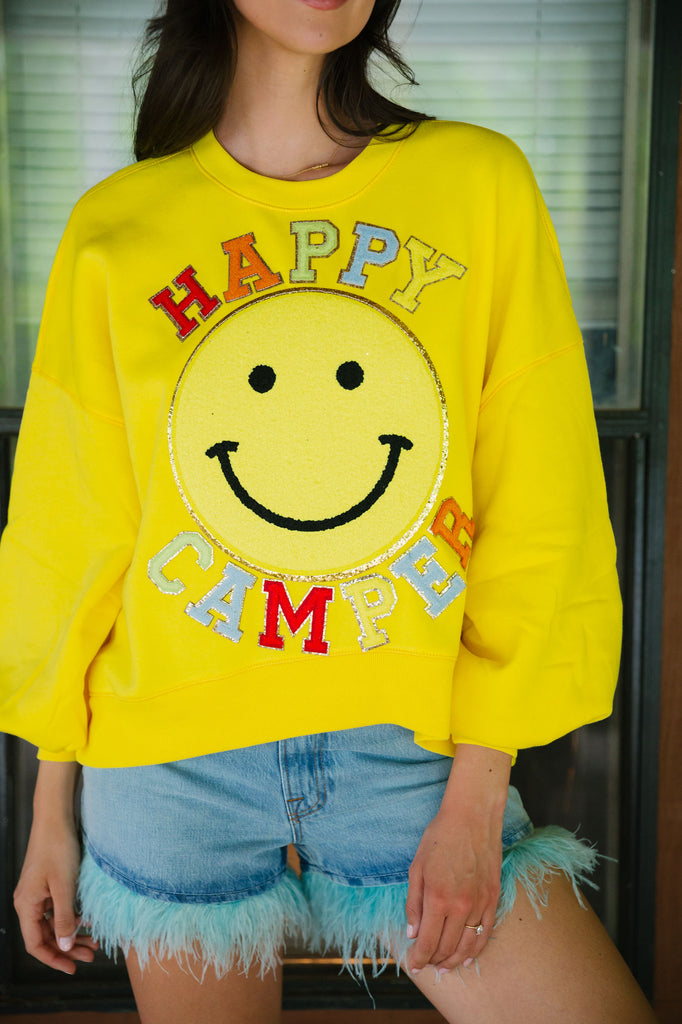 Yellow cropped pullover with Happy Camper in mini glam rainbow lettering and a big yellow smiley face patch