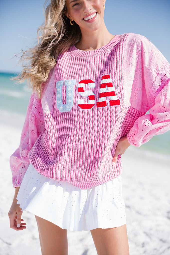 Pink sweater with American flag "USA" letters