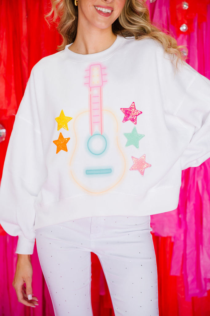 White pullover with a neon guitar and different color sequin stars 
