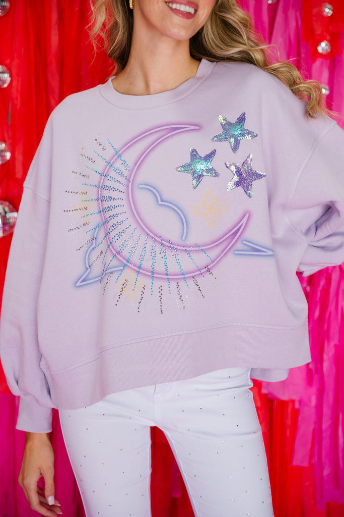 Light purple cropped pullover with a moon design, star patches, and sequin spray
