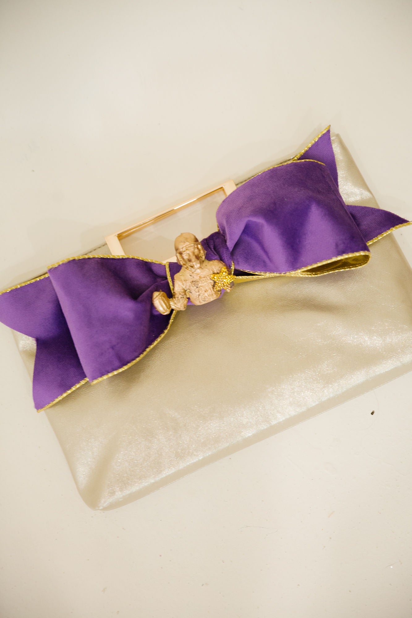 GOLDEN MVP BOW CLUTCH PURSE Judith March