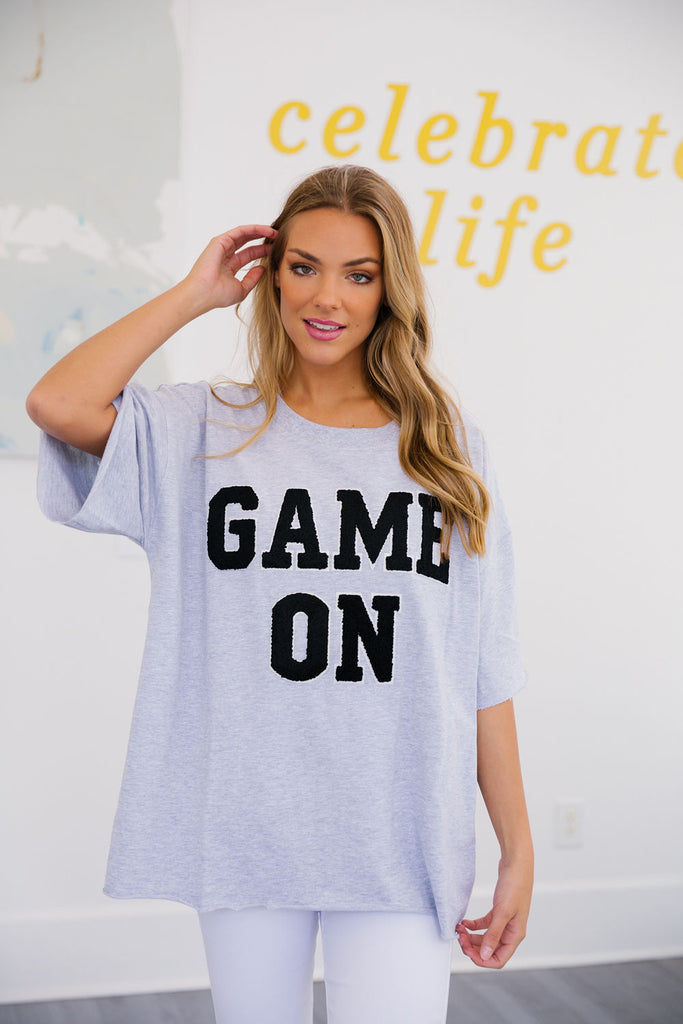 Gray tee with "game on" in black varsity lettering. 