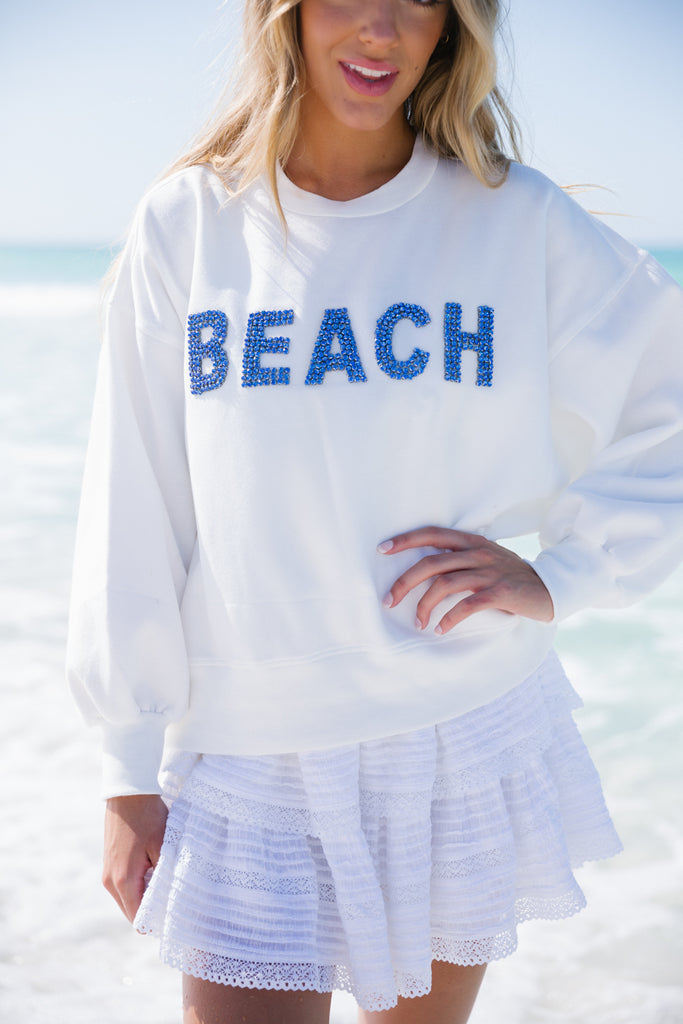 White cropped pullover with Beach in blue diamond letters