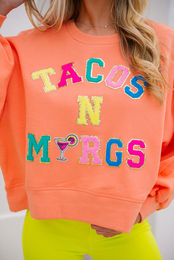 Orange cropped pullover with Tacos N Margs in rainbow terry letters