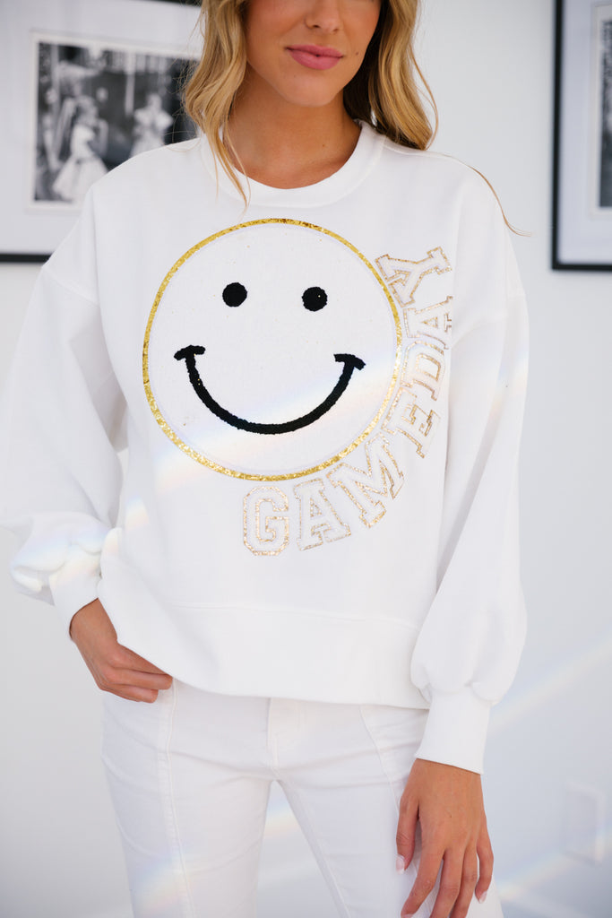 White cropped pullover with big white smiley face and Gameday in mini white glam letters