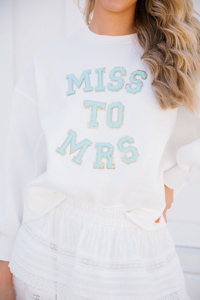 White cropped pullover with blue "Miss To Mrs" letters