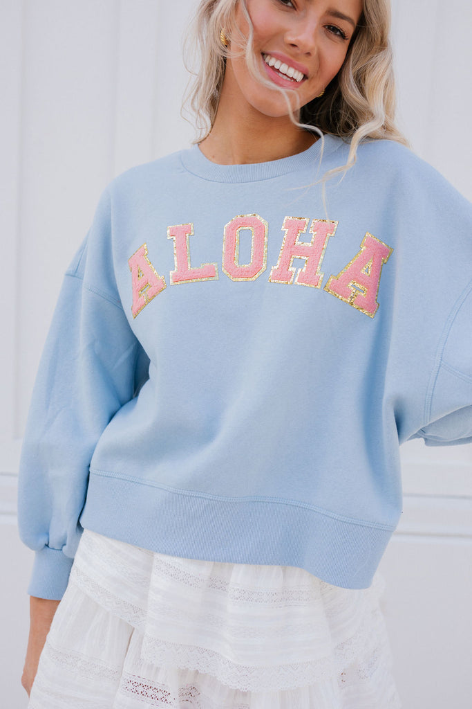 Light blue cropped pullover with Aloha in coral glam letters