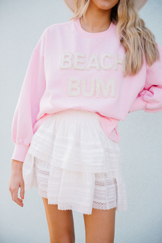 Pink pullover with Beach Bum in white beaded letters