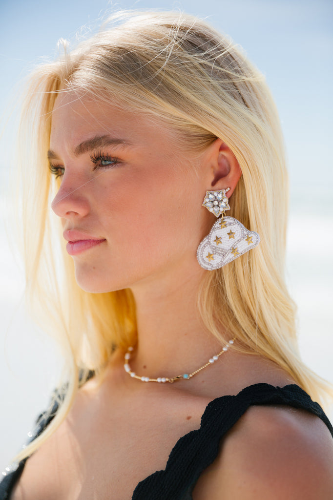 White beaded cowboy hat earrings with gold stars