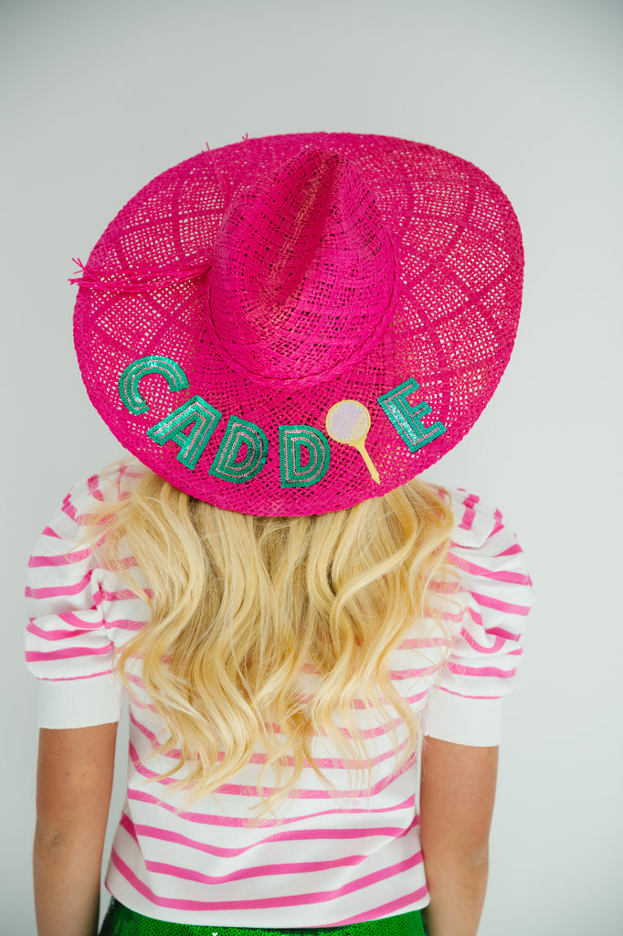 Pink straw hat with Caddie in green sequin letters with tennis racket patch