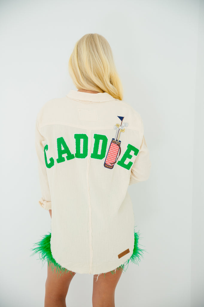 Cream button down with Caddie in green varsity letters with golf bag patch
