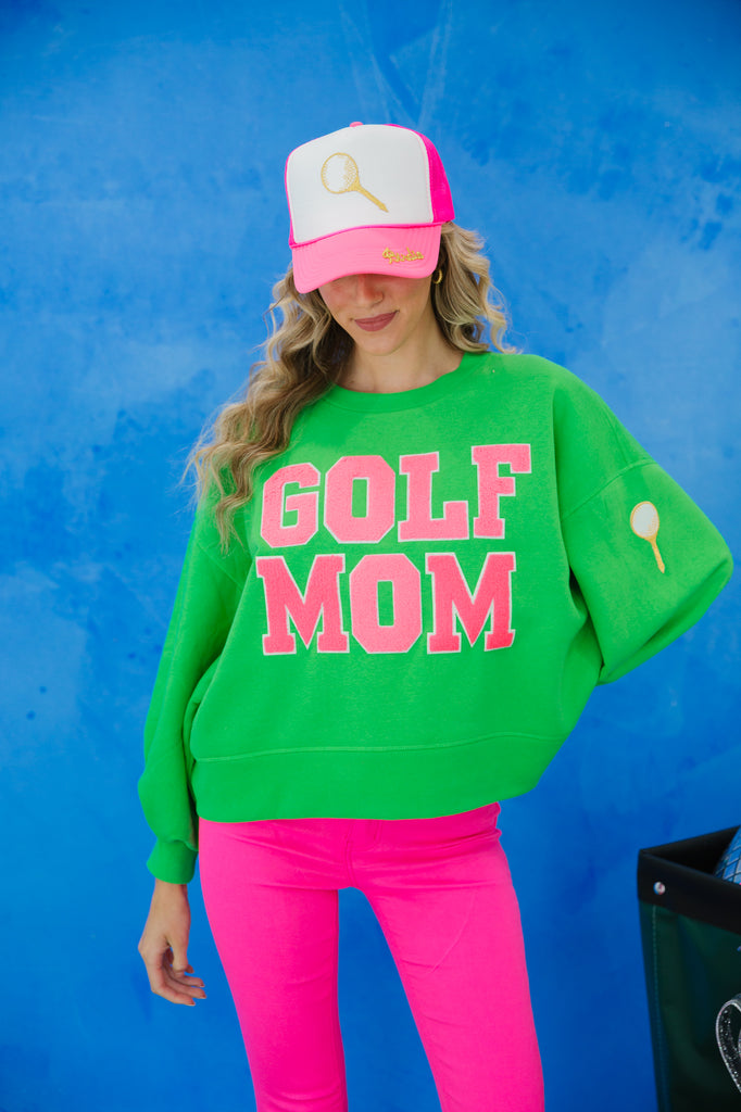 Green pullover with "golf mom" in pink varsity lettering and golf patch on the left sleeve. 