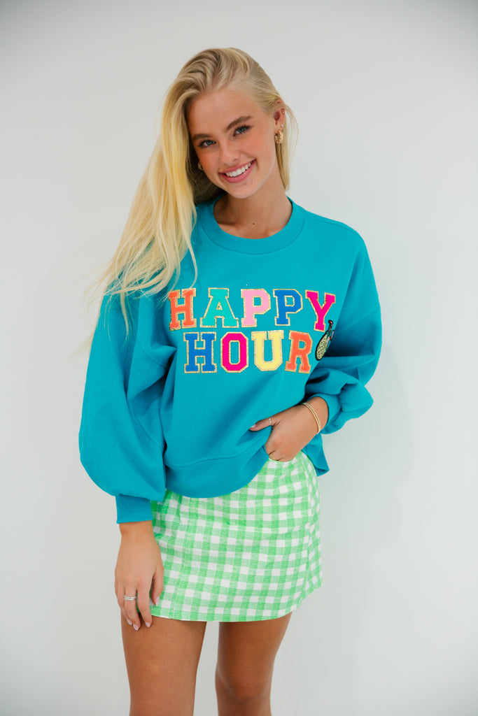 Teal cropped pullover with Happy Hour in colorful terry letters and a pineapple cocktail patch