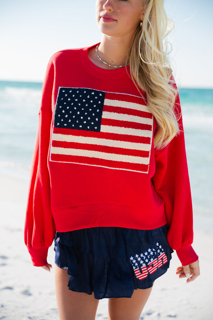 Red cropped pullover with an American flag