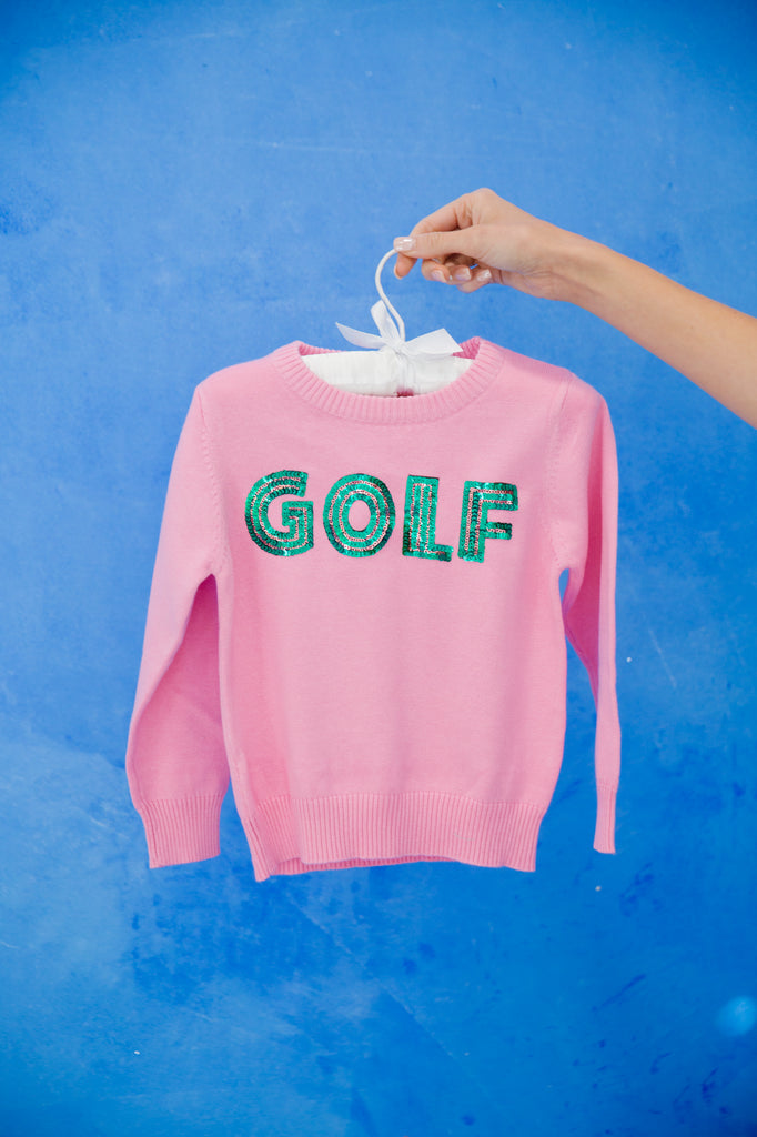 Kids pink sweater with "golf" in green sequin lettering. 