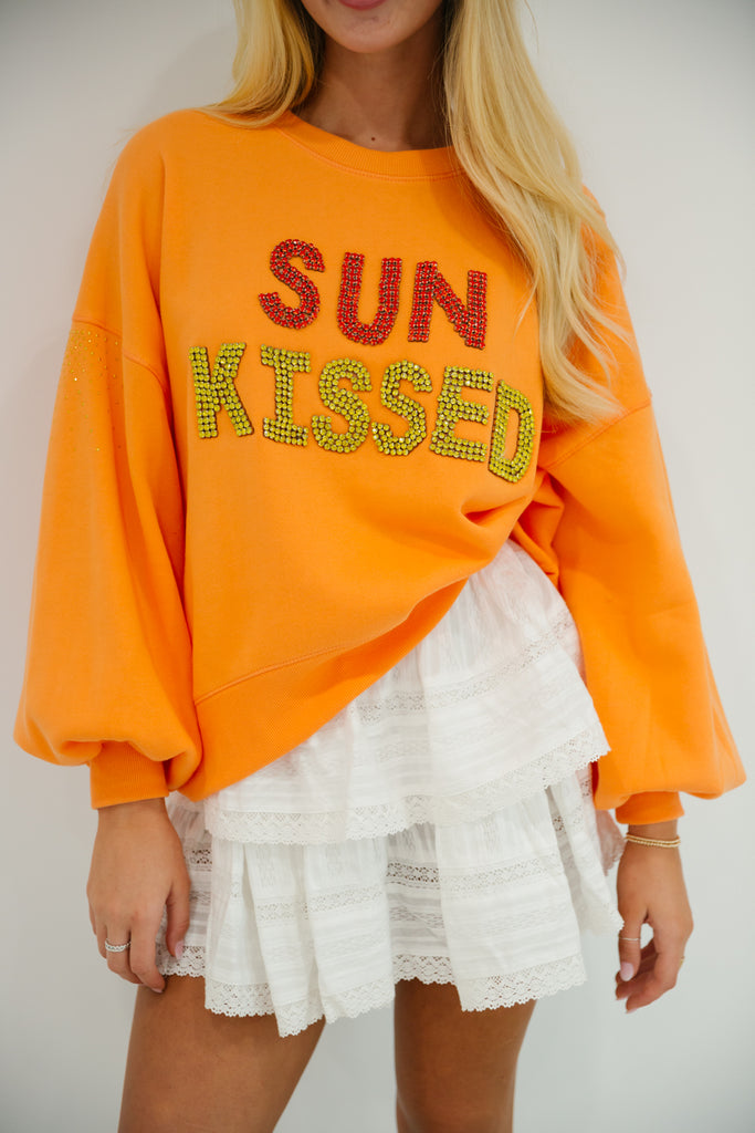 Orange cropped pullover with Sun Kissed in red and yellow diamond letters