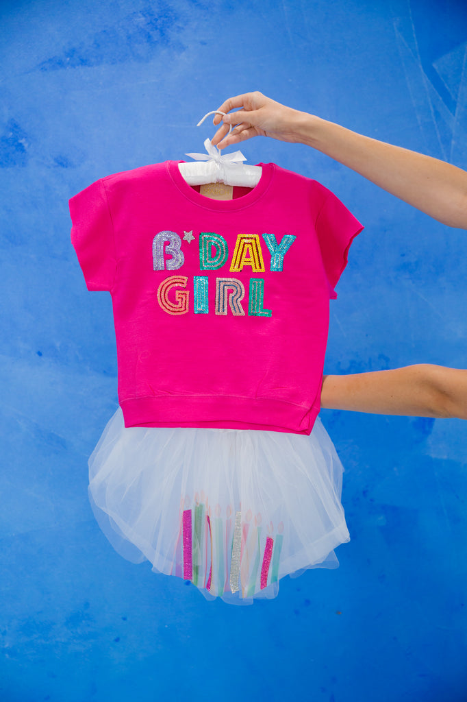 Pink short sleeve top with "bday girl" in colorful sequin lettering and a silver rhinestone heart. 